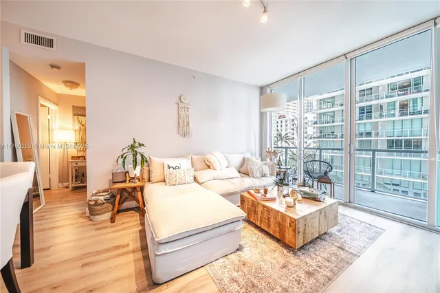 a living room with furniture and a large window