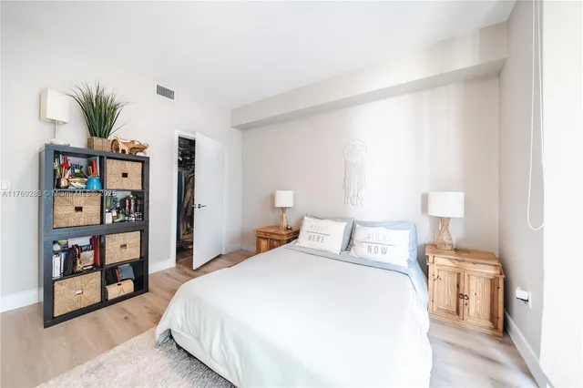 a bedroom with a bed and a book shelf