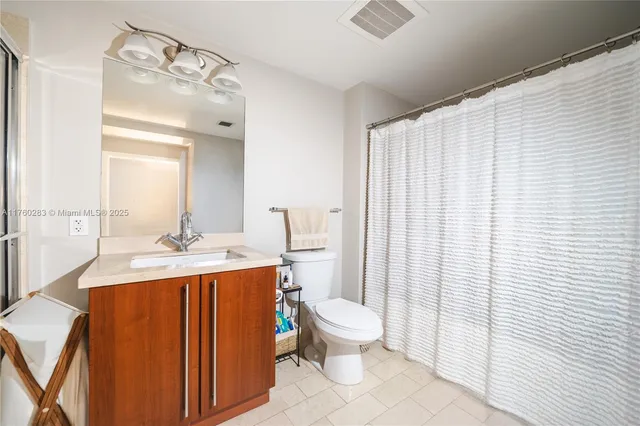 a bathroom with a sink a toilet and mirror