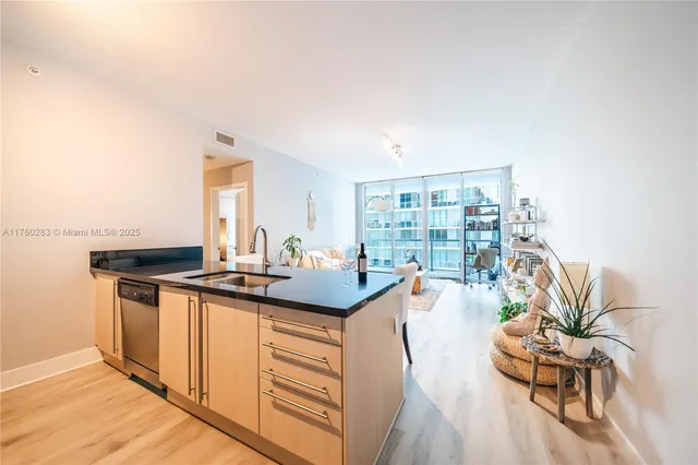 a kitchen with granite countertop a stove and a wooden floors