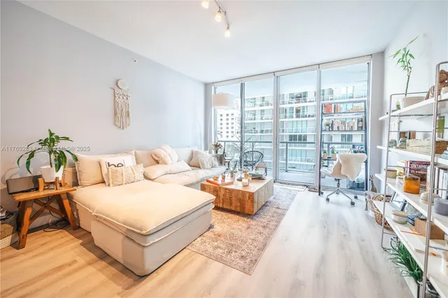 a living room with furniture and a book shelf
