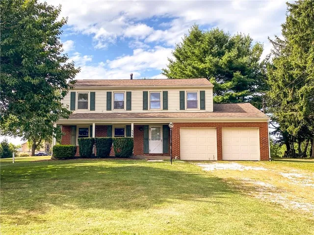 a front view of a house with a swimming pool