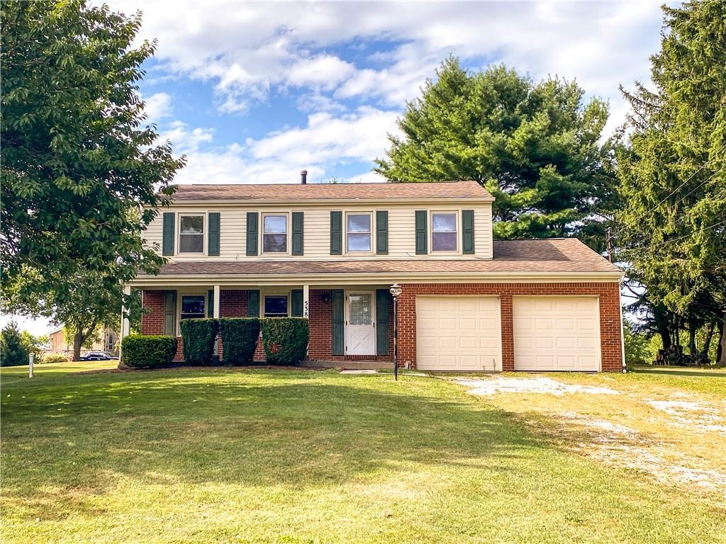 a front view of a house with a swimming pool