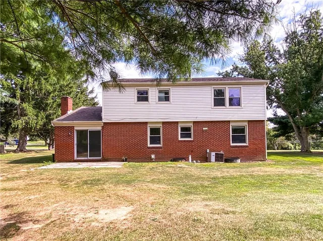 a front view of house with yard and trees