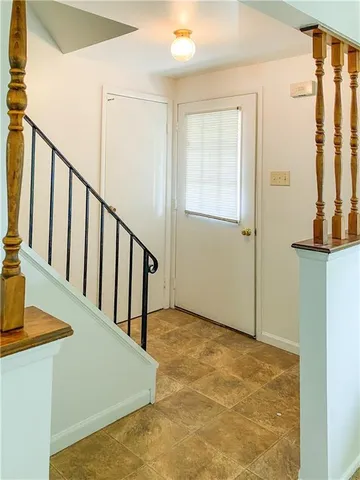a view of entryway and hall with wooden floor