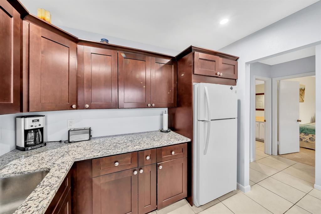 9278 Vista Del Lago, Unit 31F Boca Raton, FL 33428 - Photo 12 of 33 a kitchen with a refrigerator sink and cabinets