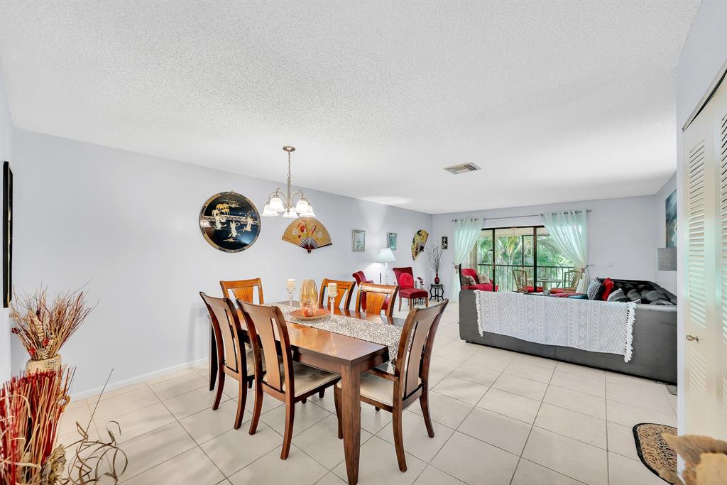 9278 Vista Del Lago, Unit 31F Boca Raton, FL 33428 - Photo 15 of 33 a dining room with furniture and window