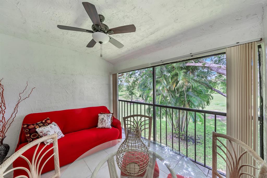9278 Vista Del Lago, Unit 31F Boca Raton, FL 33428 - Photo 16 of 33 a living room with furniture and a large window