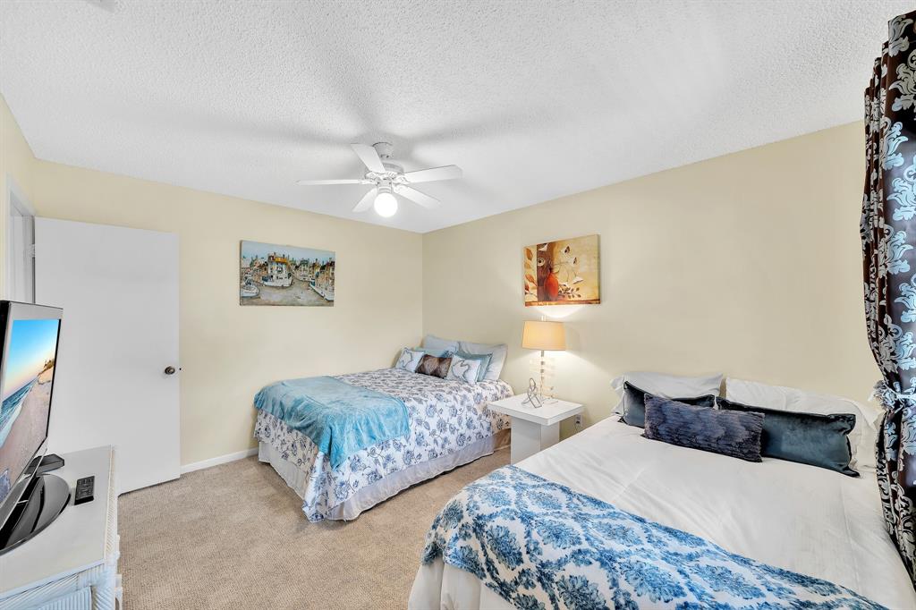 9278 Vista Del Lago, Unit 31F Boca Raton, FL 33428 - Photo 18 of 33 a bedroom with two beds and a view of bathroom