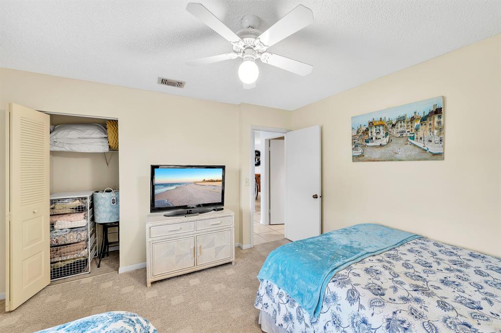 9278 Vista Del Lago, Unit 31F Boca Raton, FL 33428 - Photo 19 of 33 a bedroom with a bed and a flat screen tv