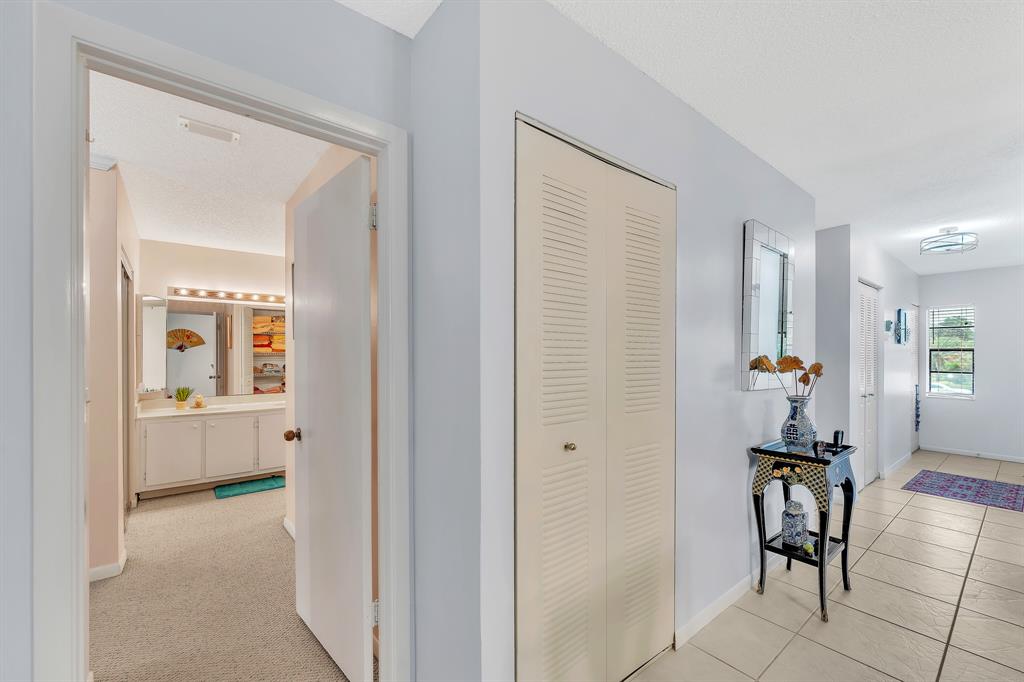 9278 Vista Del Lago, Unit 31F Boca Raton, FL 33428 - Photo 30 of 33 a view of a hallway with wooden floor windows and a livingroom