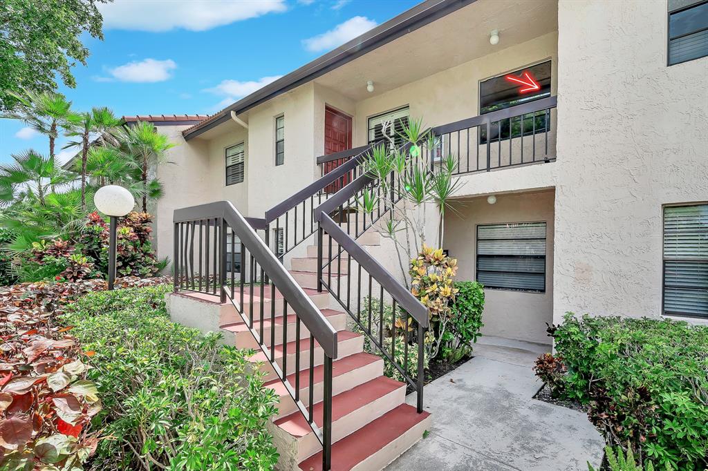 9278 Vista Del Lago, Unit 31F Boca Raton, FL 33428 - Photo 5 of 33 a view of entryway with flower pots and wooden floor