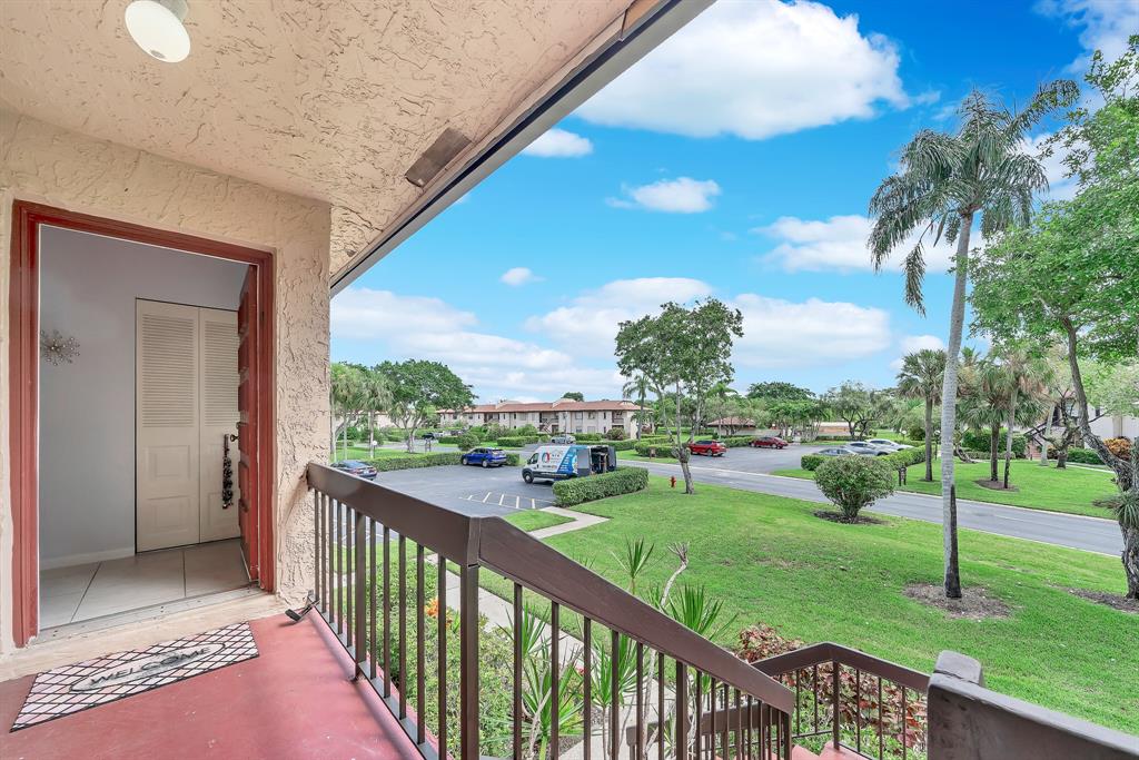 9278 Vista Del Lago, Unit 31F Boca Raton, FL 33428 - Photo 6 of 33 a view of a porch and garden