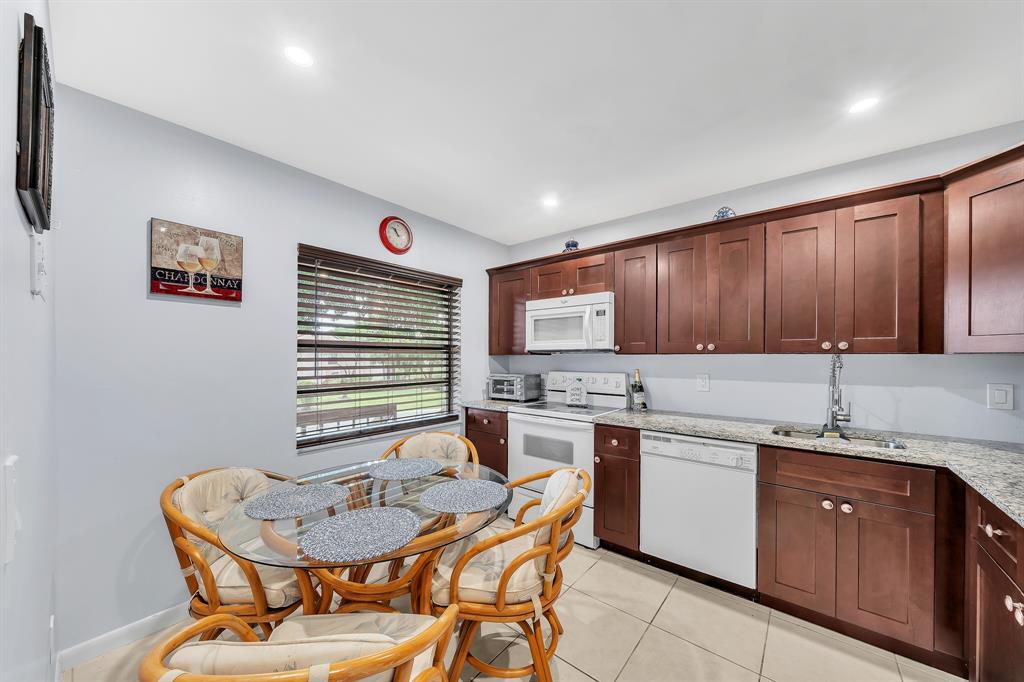 9278 Vista Del Lago, Unit 31F Boca Raton, FL 33428 - Photo 9 of 33 a kitchen with a sink cabinets and window