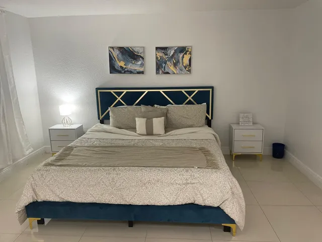 a bedroom with a bed and wall painting