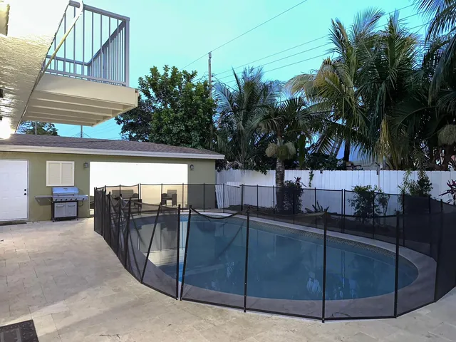 a view of a chairs and table in the back yard of the house