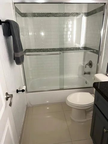 a bathroom with a toilet a sink and a shower