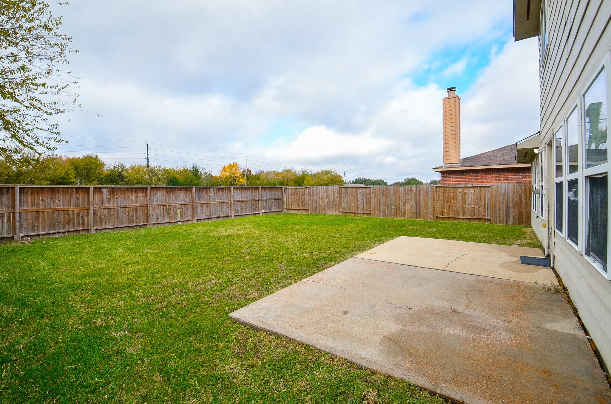 7134 Winston Ranch Parkway Richmond, TX 77406 - Photo 32 of 35 Sturdy privacy fencing surrounds the entire backyard and good-sized patio. Picture seasonal entertaining out here under a colorful table with huge tilting umbrella, chairs, or rustic benches.