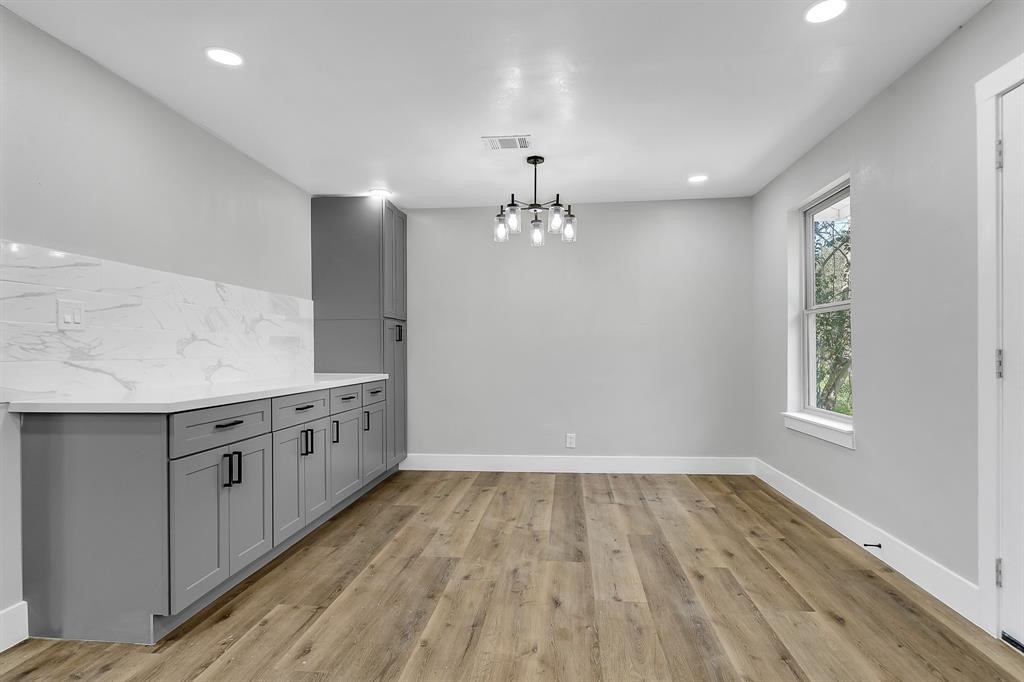 7609 St Lo Road Houston, TX 77033 - Photo 9 of 14 wooden floor in an empty room with a window