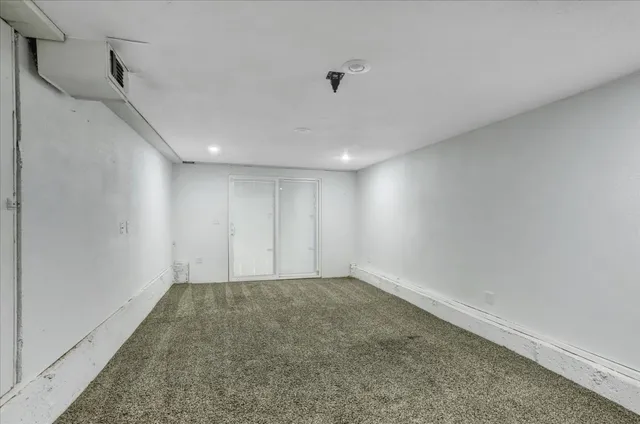 a view of a house with backyard and trees