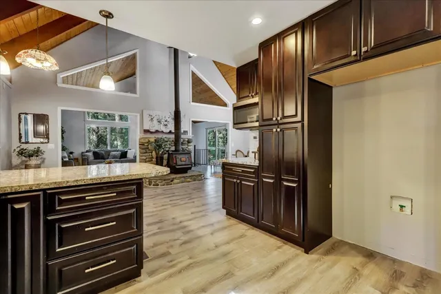 a kitchen with granite countertop stainless steel appliances and cabinets