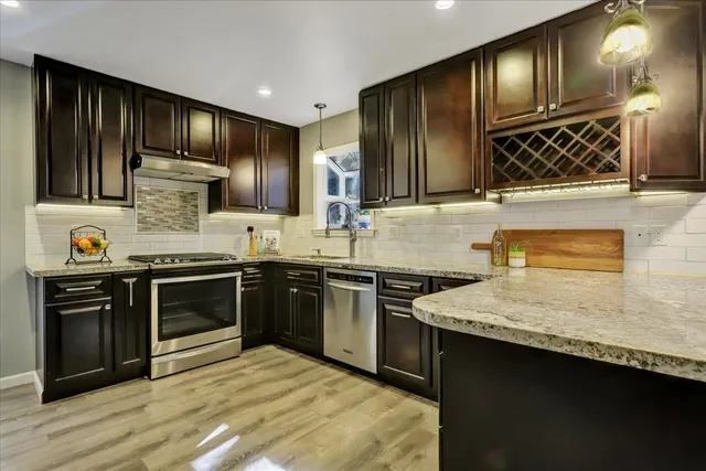 a kitchen with stainless steel appliances granite countertop a stove and a sink