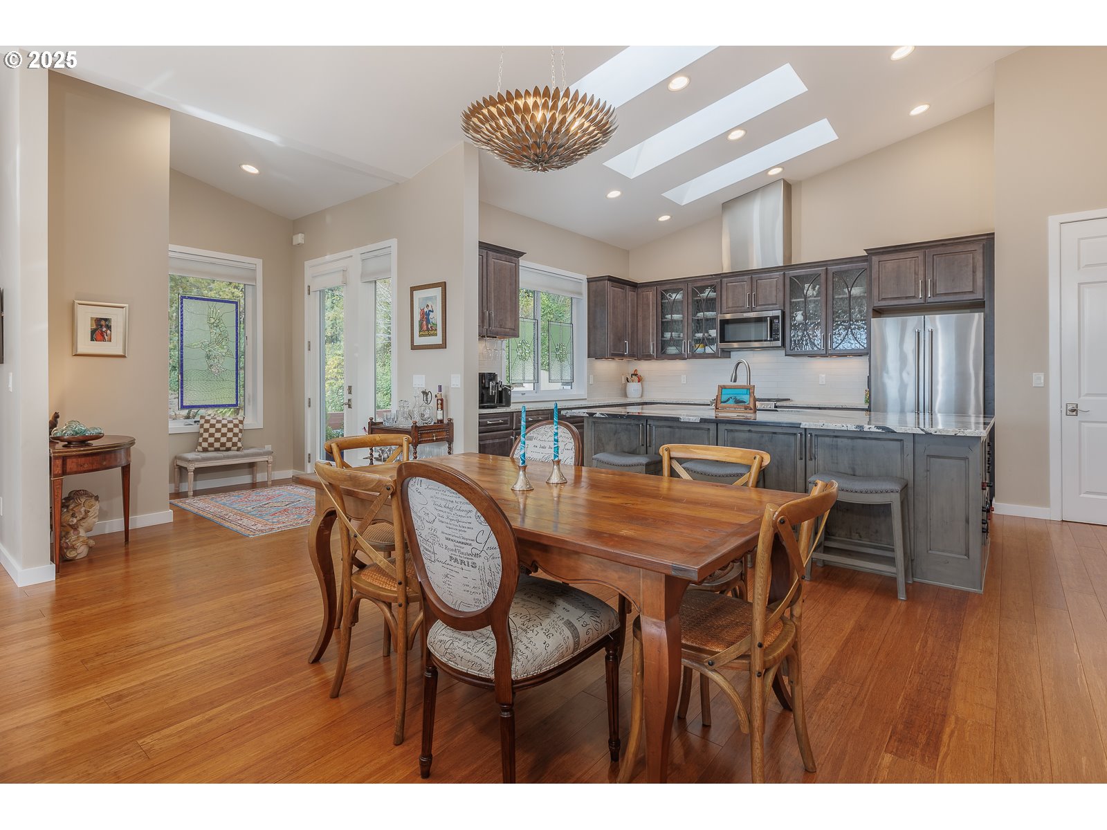 108 Sea Crest Court Otter Rock, OR 97369 - Photo 11 of 45 a dining room with stainless steel appliances kitchen island granite countertop furniture and wooden floor
