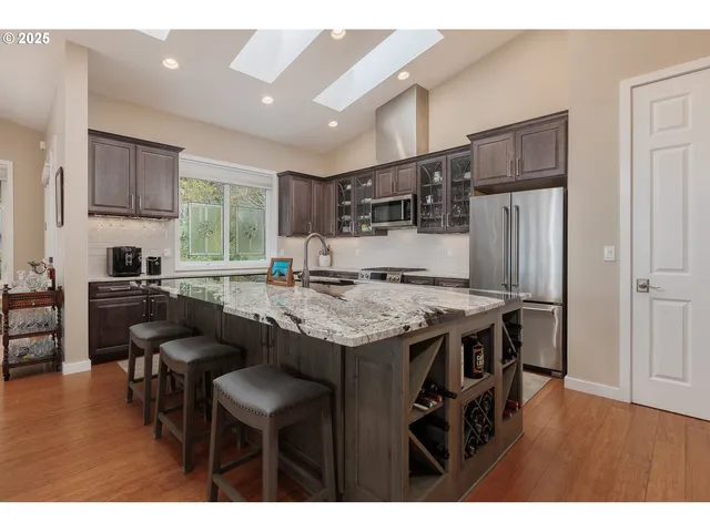 a kitchen with kitchen island a stove a table and chairs