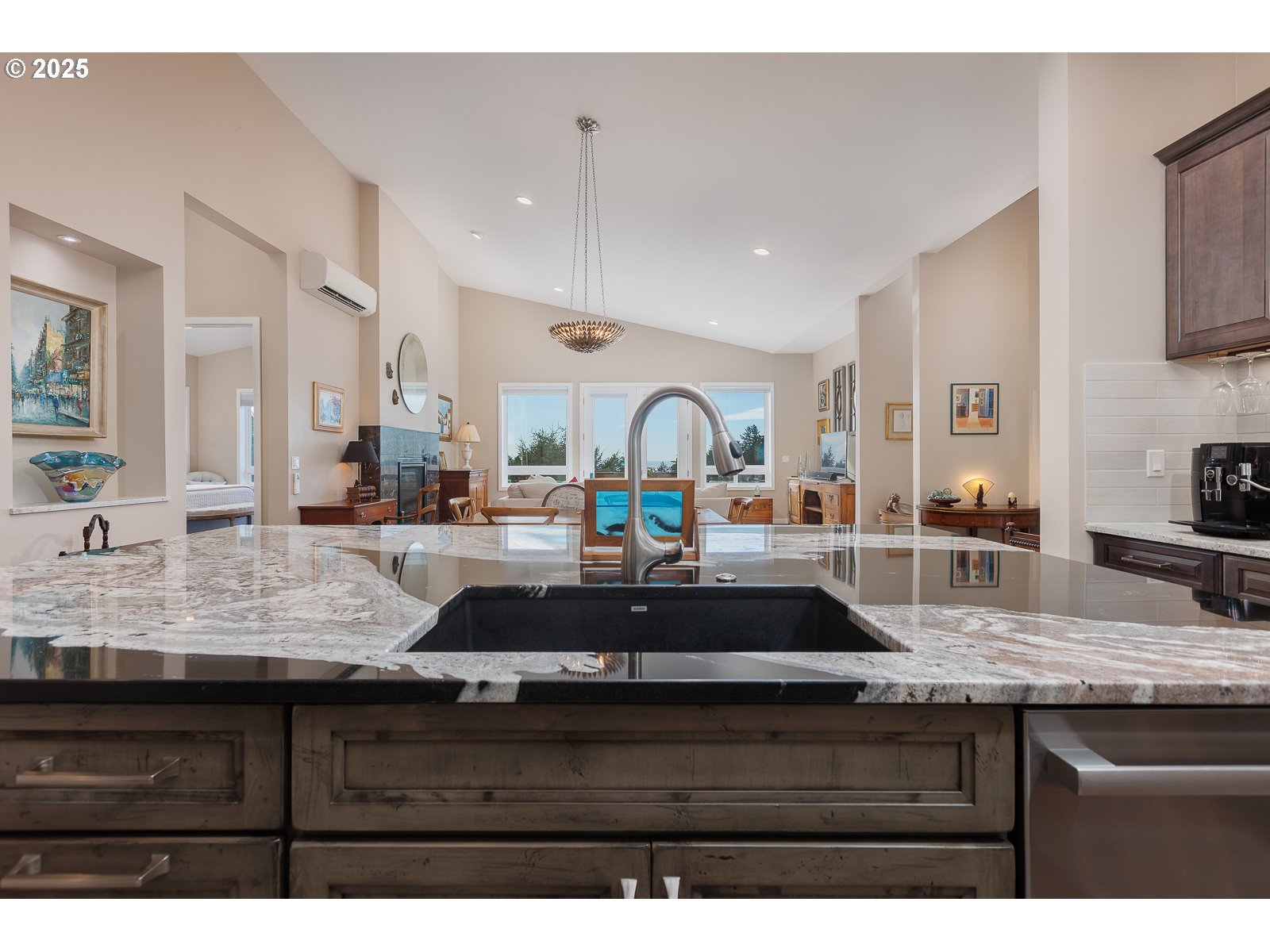 108 Sea Crest Court Otter Rock, OR 97369 - Photo 16 of 45 a kitchen with kitchen island granite countertop a sink a counter space and cabinets