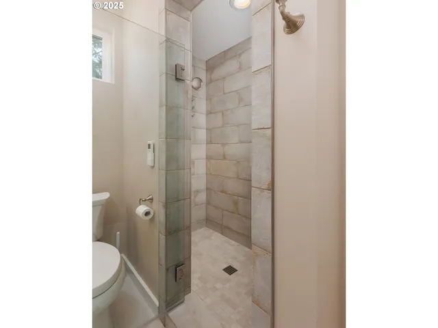 a bathroom with a shower and a toilet