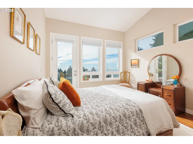 a bedroom with a bed and a large window