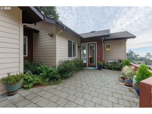 a view of backyard of a house with potted plants