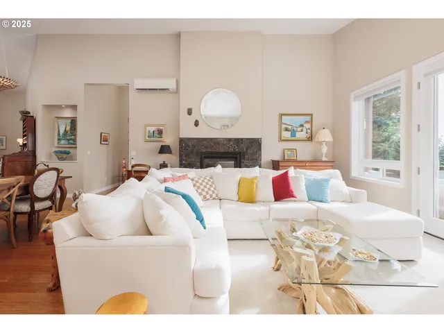 a living room with furniture a lamp and a large window