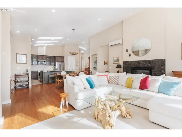 a living room with furniture kitchen view and a table