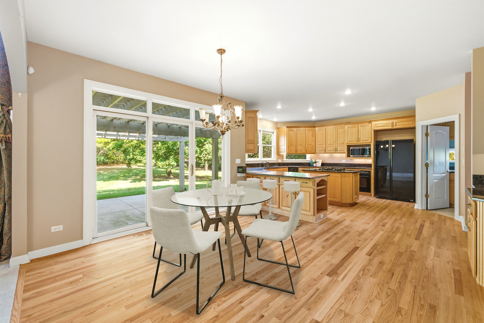 37-w004 Ridgewood Drive St. Charles, IL 60175 - Photo 14 of 44 a view of a dining room with furniture large windows and wooden floor