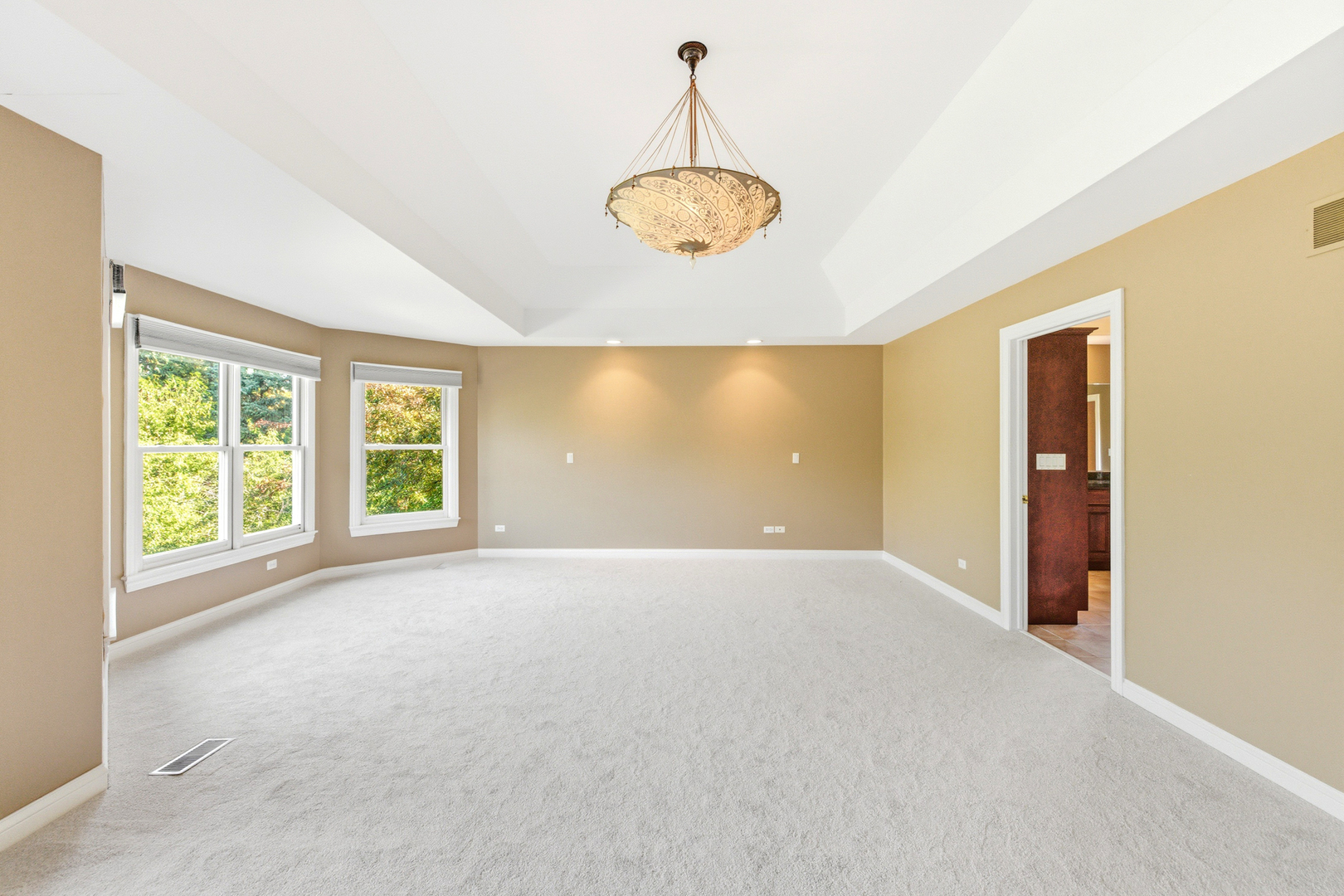 37-w004 Ridgewood Drive St. Charles, IL 60175 - Photo 24 of 44 an empty room with windows and chandelier