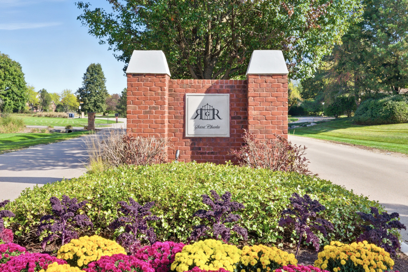 37-w004 Ridgewood Drive St. Charles, IL 60175 - Photo 3 of 44 a sign that is in front of flowers