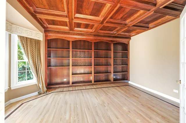 a view of a room with wooden floor and a kitchen space