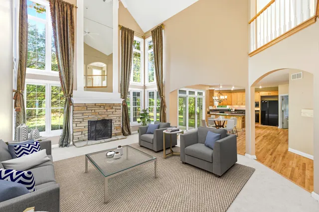 a spacious bedroom with a large window and a fireplace