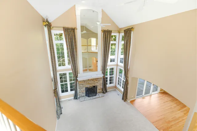 a view of a dining room with furniture large windows and wooden floor