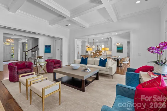 a living room with furniture and a mirror