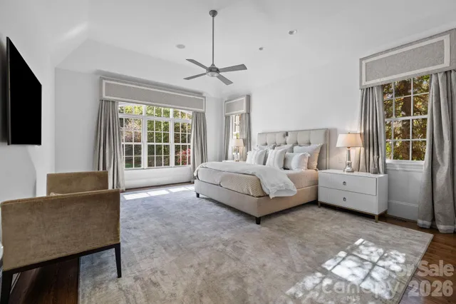 a spacious bedroom with a bed and a couch