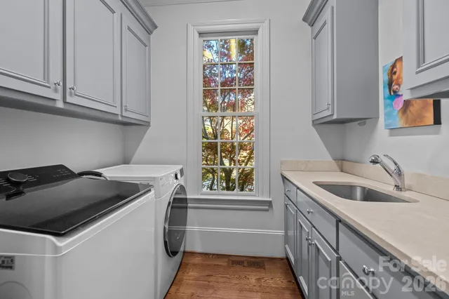 a view of kitchen with sink and wooden floor