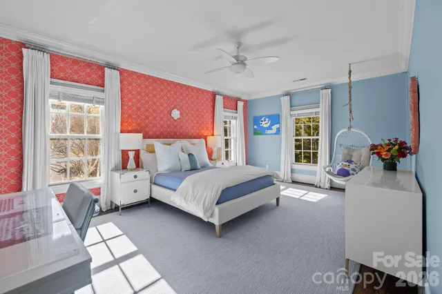 a bedroom with a bed and a chandelier