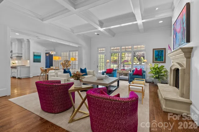 a living room with fireplace furniture and a large window