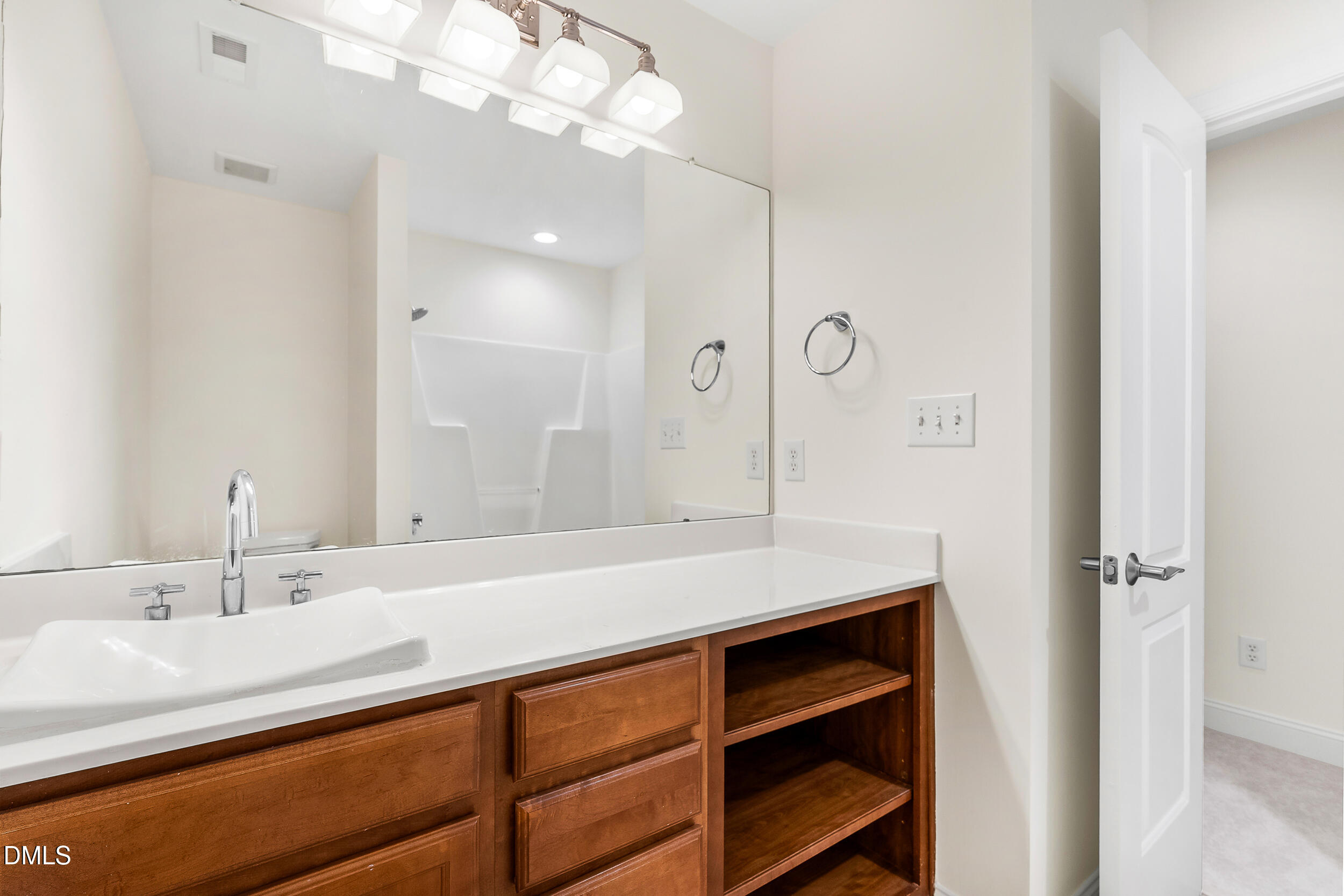 2822 Pickett Road, Unit 154 Durham, NC 27705 - Photo 17 of 31 a bathroom with a sink a vanity and a large mirror