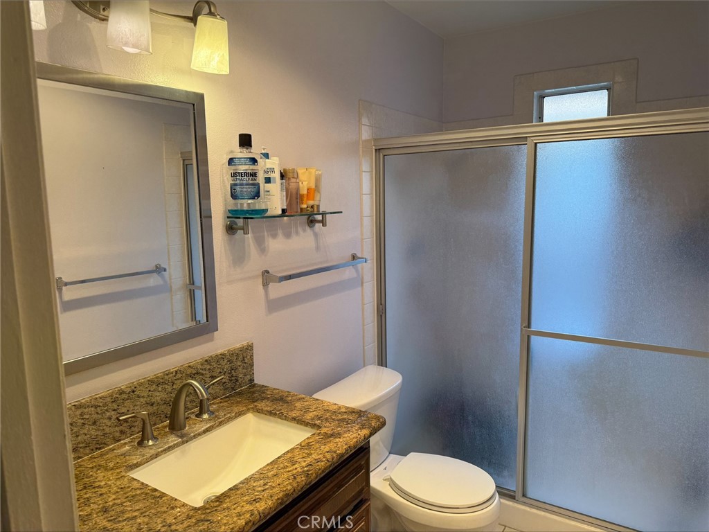 1114 Bottle Tree Way Hemet, CA 92545 - Photo 13 of 23 a bathroom with a granite countertop sink toilet and shower