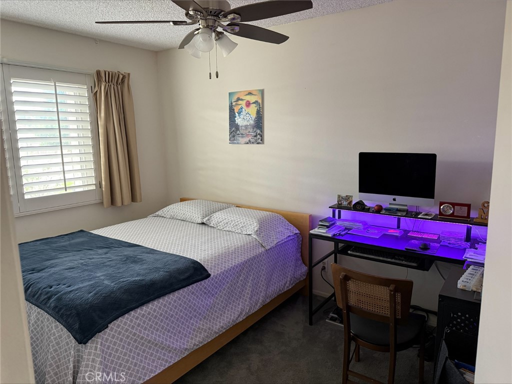 1114 Bottle Tree Way Hemet, CA 92545 - Photo 14 of 23 a bedroom with a bed and a flat screen tv