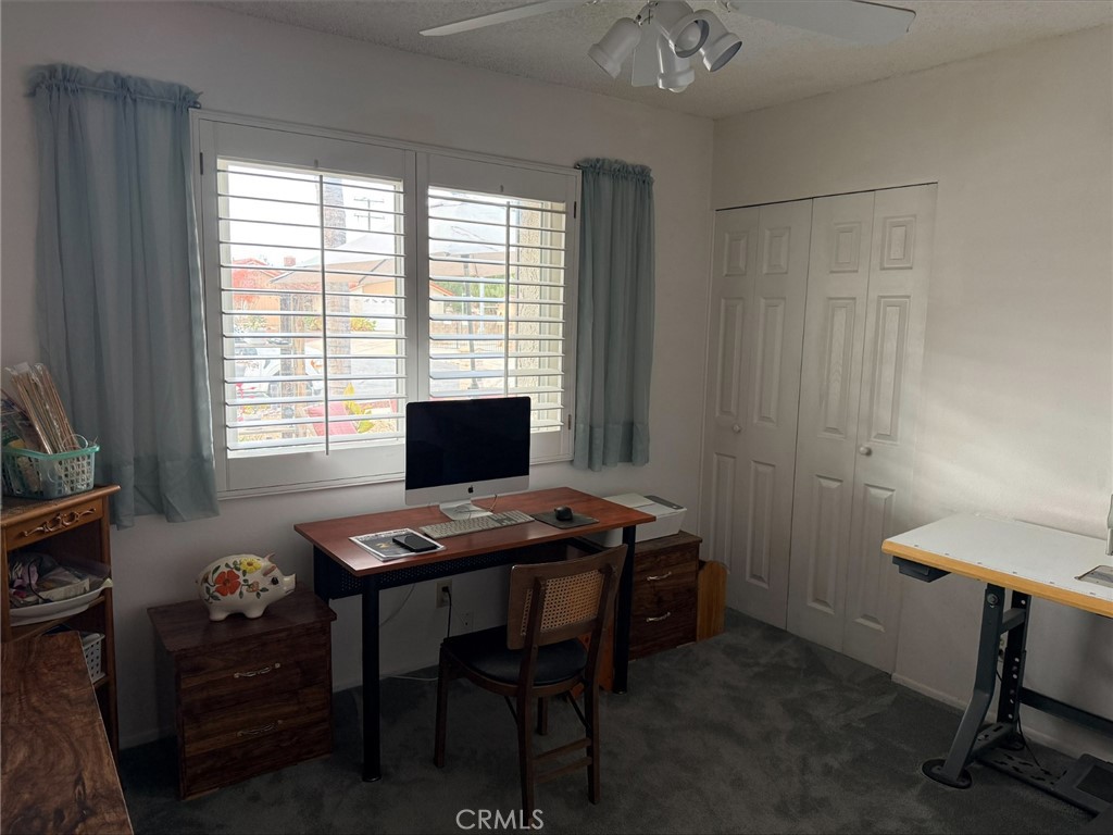 1114 Bottle Tree Way Hemet, CA 92545 - Photo 15 of 23 a view of a workspace with furniture and a window