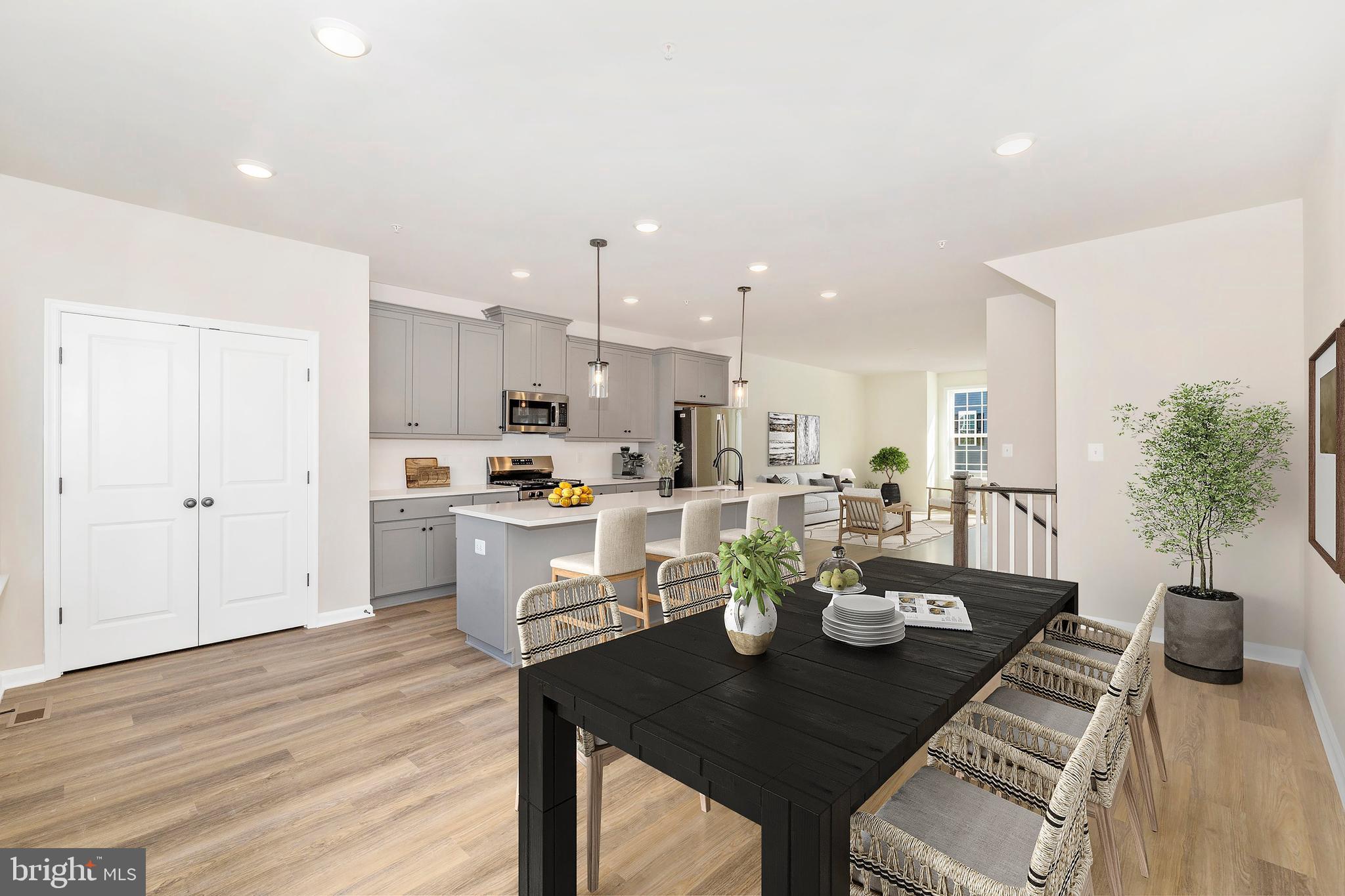 103 Spring Bank Way Frederick, MD 21701 - Photo 4 of 13 a view of a dining room with furniture and wooden floor